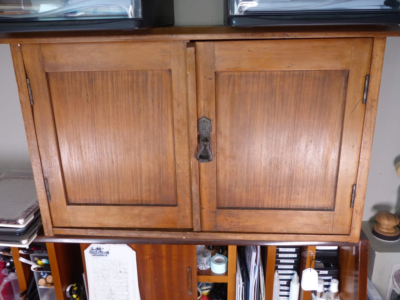 Wooden cupboards on writers desk, full of ink pads, washi tape and card making supplies