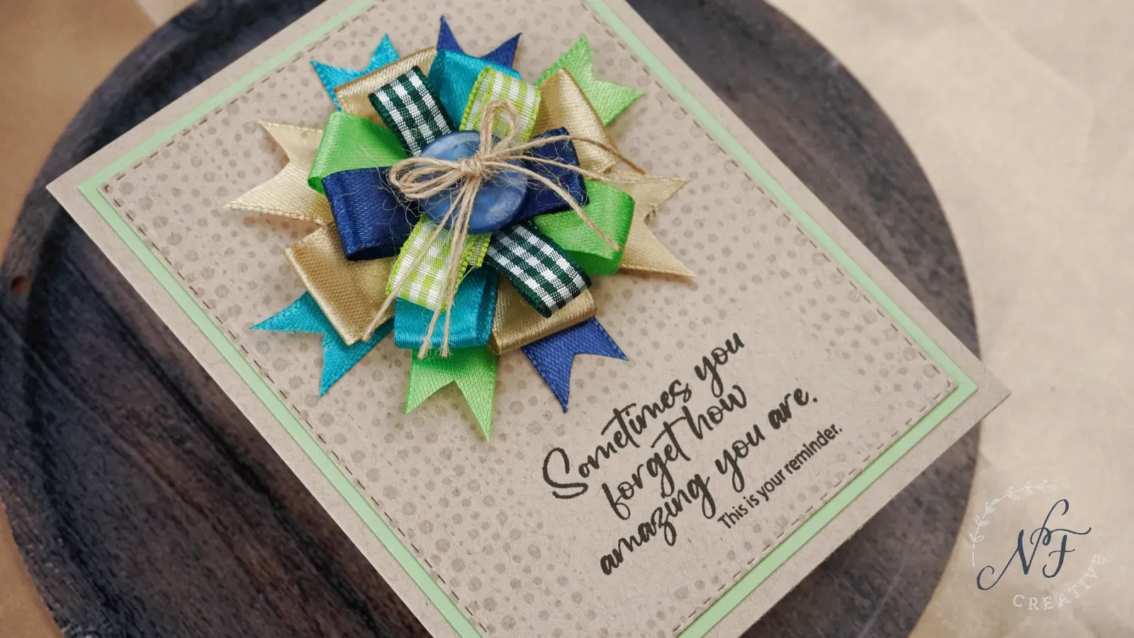 Beautiful blue, gold and green ribbon rosette on kraft cardstock