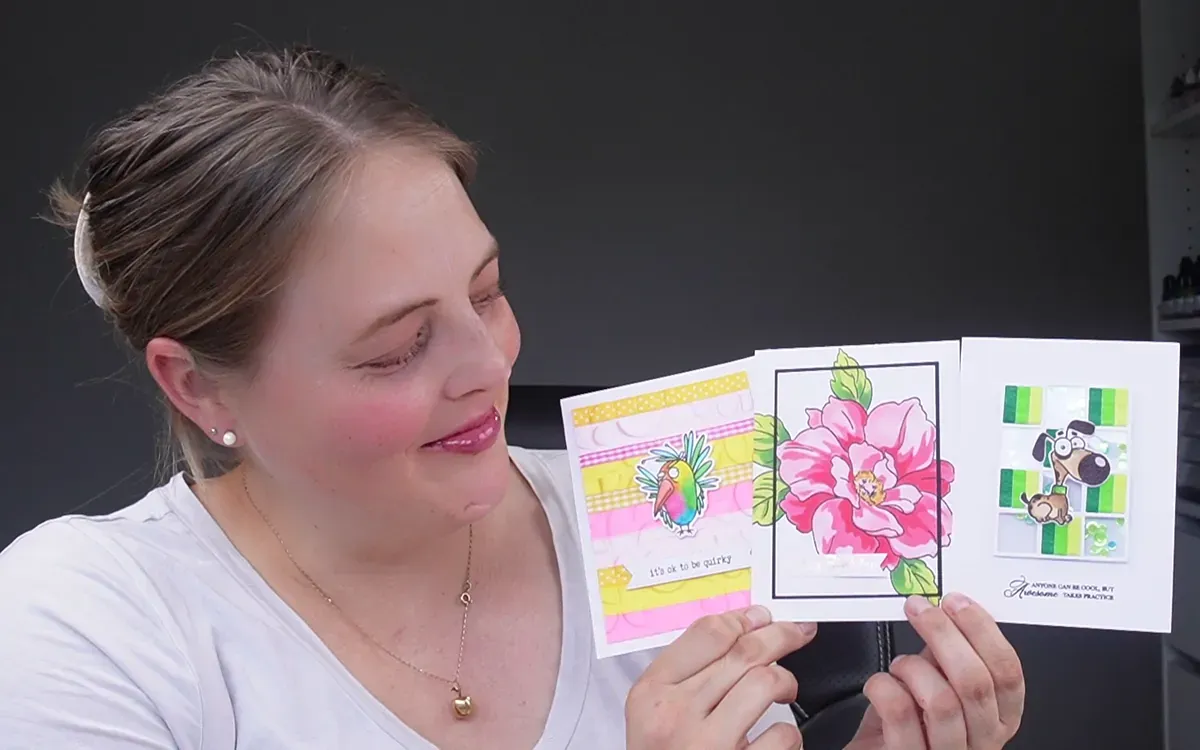 Natasha Foote holding three handmade cards.